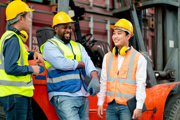 Multi ethnic cargo contianer workers stand and relax with happiness during work in workplace area.