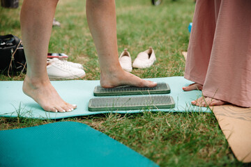 Alternative medicine and mindfulness practice - standing on sadhu board nails barefoot