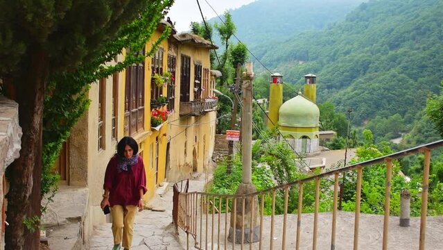 Tourist walk around Masuleh historical village in north east Iran - popular famous tourism destination in persia