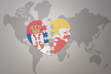 puzzle heart with the national flag of bhutan and serbia on a world map background.Concept.