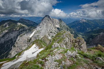 Fototapeta na wymiar Mountain hiking Trail Road. Between Italy and Austria: near Volaia Lake Raunchkofer Mountain (Lago di Volaia Monte Rauchkofel