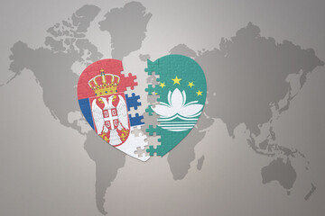 puzzle heart with the national flag of Macau and serbia on a world map background.Concept.
