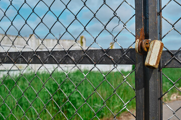 Brass padlock was locked with wire mesh door fence