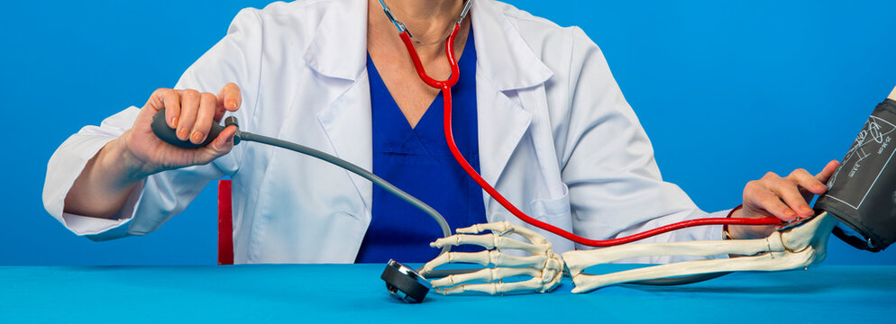 doctor measures the pressure of the human skeleton close-up
