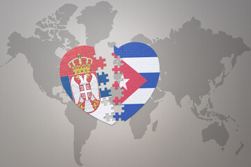 puzzle heart with the national flag of cuba and serbia on a world map background.Concept.