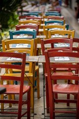 Clolored Wooden Chairs on Sidewalk in the City of Cagliari, in the Region of Sardinia, Italy, in Summer