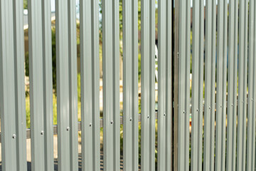 Steel fence. Fence around area. Grey steel profile.