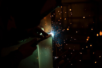 Welding work. High temperature. Hot steel. Metal welding. Production details.