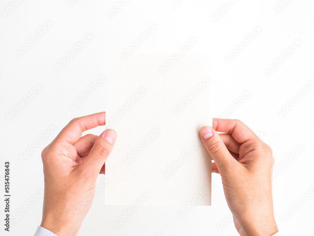 Wall mural female hands hold a blank postcard on a white background. template, empty space for text