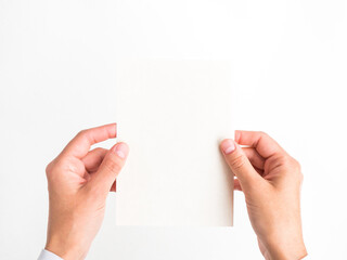 female hands hold a blank postcard on a white background. template, empty space for text