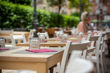 Close Up on Tables and Colored Chairs on the Street Waiting to be Used by Tourists in Summer