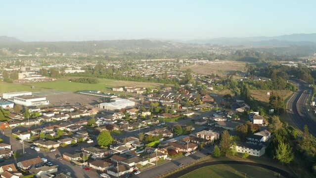 Aerial view of Fortuna, suburban town with redwood forest mountain in background