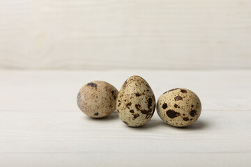 Quail eggs on a white texture background. Natural products. Place for text. Fresh quail eggs.