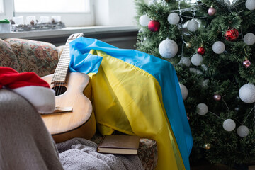 Ukraine flag and gift box on the background of the Christmas tree