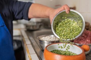 Hand of a woman preparing ingredients for a ceviche in a restaurant