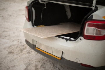 Board in trunk of car. Trunk of transport. Transportation of goods.