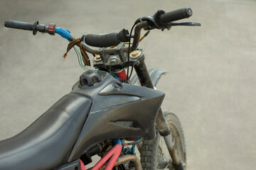 Sports motorcycle. Cross bike is in parking lot. Personal transport on two wheels.