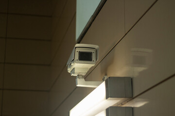 Surveillance video camera. Security system in the subway. Video recording in a public place. Citizen recognition system.