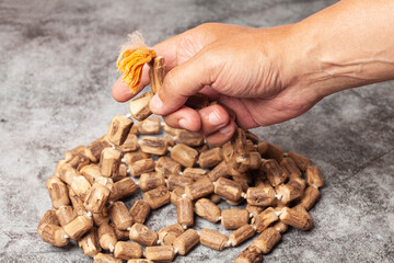 Rosary or prayer beads in a man's hand isolated on white background.