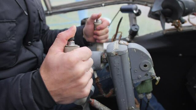 Male hands of the pilot take the steering wheel of the plane. Vintage style. The old historical cabin AN-2.