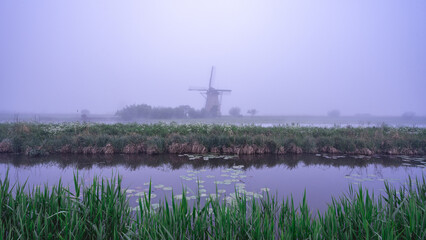 Foggy morning at the windmills at Kinderdijk, The Netherlands.