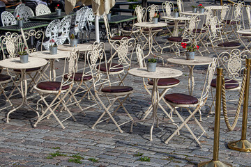 Cute Ivory and Burgundy Bistro Tables Line an Outdoor Seating Area at a Café in Kungsträdgården Park in Stockholm, Sweden