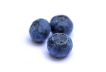 three berries lie on a white background