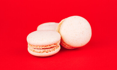 White macaroons on a red background