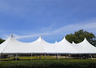 a large white eight peak entertainment or wedding tent on a summer day - 515483656