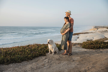 Pregnant couple and their dog