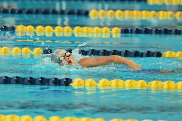 Young boy competing in a Swim Meet doing the breast stroke, butterfly, backstroke and freestyle