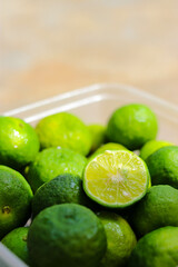 Top view of Lime or Limau (Citrus amblycarpa) slice with a large group of limau background