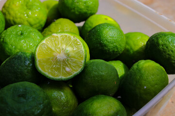 Top view of Lime or Limau (Citrus amblycarpa) slice with a large group of limau background