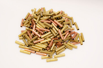 pile of copper pipes on a white background