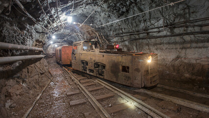 Naklejka premium Old rusty train in iron ore mine.