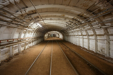 Dark tunnel in iron ore mine.