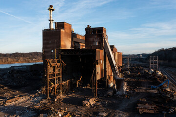 Fototapeta premium Aerial of Rusted and Basic Oxygen Furnace and Caster Undergoing Demolition at Sunset - Abandoned Armco Steel / AK Steel Ashland Works - Russell and Ashland, Kentucky
