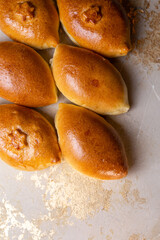 Fried homemade pies with potatoes on the kitchen table. Grandma's recipe. View from above.