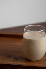 banana smoothie with chia seeds on a wooden table