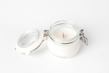 Obraz na płótnie Canvas Soy candles in glass cans, handmade modern hobby , harmless coconut wax candles without paraffin with wood on white background isolated