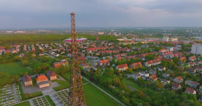 Aerial view of the wooden broadcasting tower in Gliwice with the city of Gliwice in the background. The concept of the largest wooden tower in the world. Wooden construction from a drone.