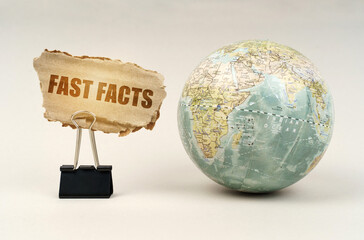 Near the globe there is a clip with a cardboard plate on which it is written - Fast Facts