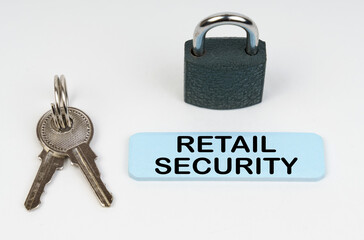 On a white surface there is a lock, keys and a blue sign with the inscription - Retail security