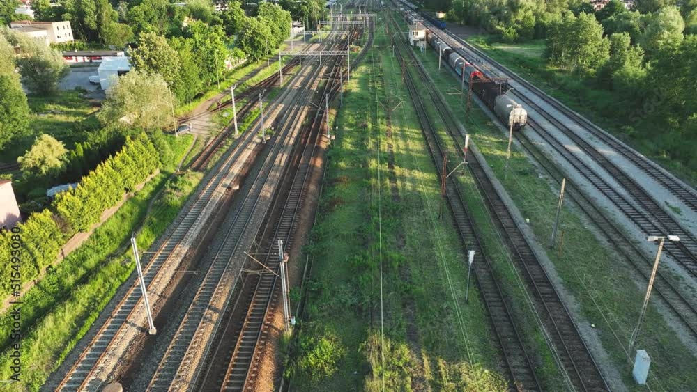 Poster the view from the drone on the railroad tracks against the background of the setting sun. concept of