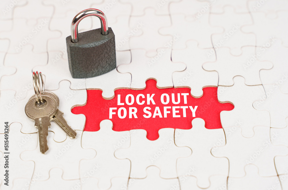 Poster on puzzles there is a lock and keys, on a red surface there is an inscription - lock out for safety