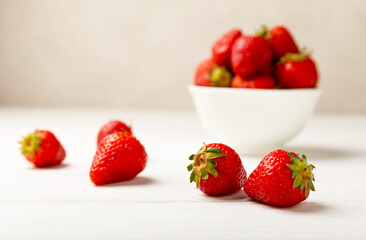 Fresh ripe strawberries in a plate on a white wooden background.Vegetarian organic berry.Healthy food.Vitamins.Copy space.Space for text