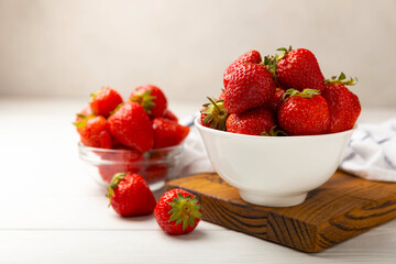 Fresh ripe strawberries in a plate on a white wooden background.Vegetarian organic berry.Healthy food.Vitamins.Copy space.Space for text