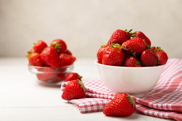 Fresh ripe strawberries in a plate on a white wooden background.Vegetarian organic berry.Healthy food.Vitamins.Copy space.Space for text