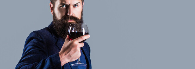 Man holding bottle with champagne, wine. Bottle, red wine glass. Beard man, bearded, sommelier,...