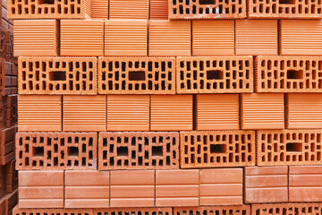 Stacked red bricks at a construction site close up